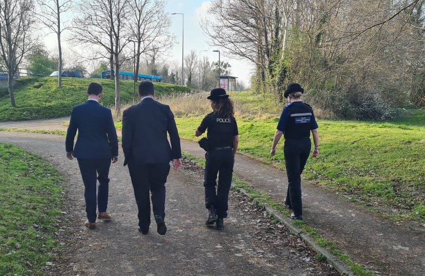 Iain walking with police officers